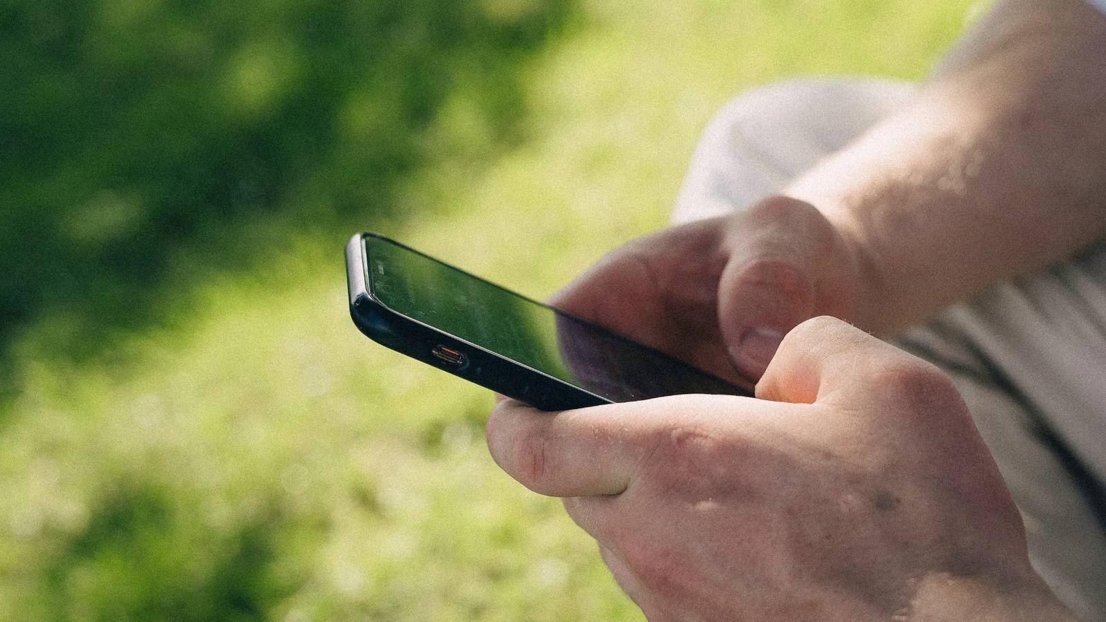A grower checking a record on a phone in the field